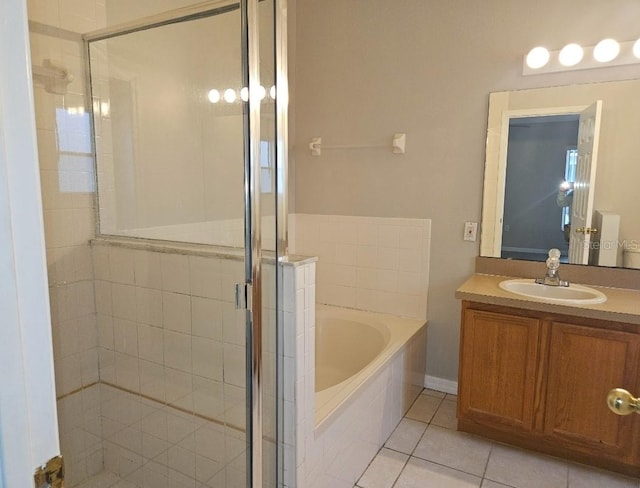 bathroom featuring tile patterned flooring, shower with separate bathtub, and vanity