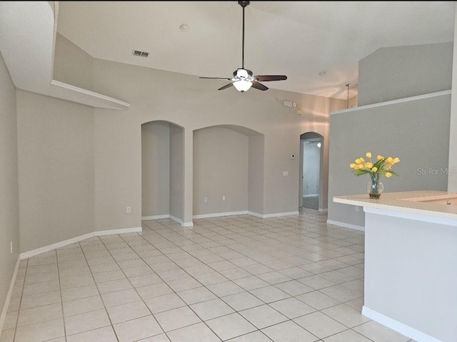 tiled spare room with vaulted ceiling and ceiling fan