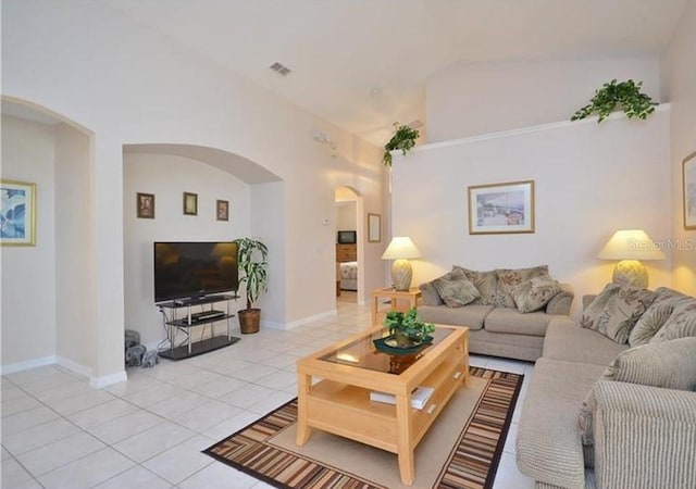 tiled living room with vaulted ceiling