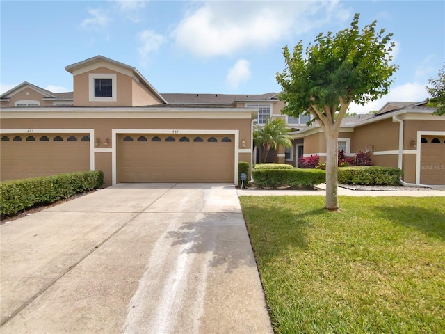 view of front of home with a garage and a front lawn