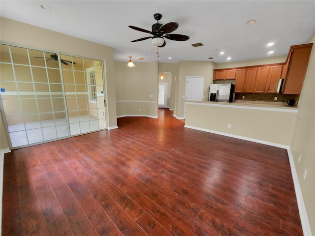 interior space featuring hardwood / wood-style floors, ceiling fan, backsplash, and stainless steel appliances