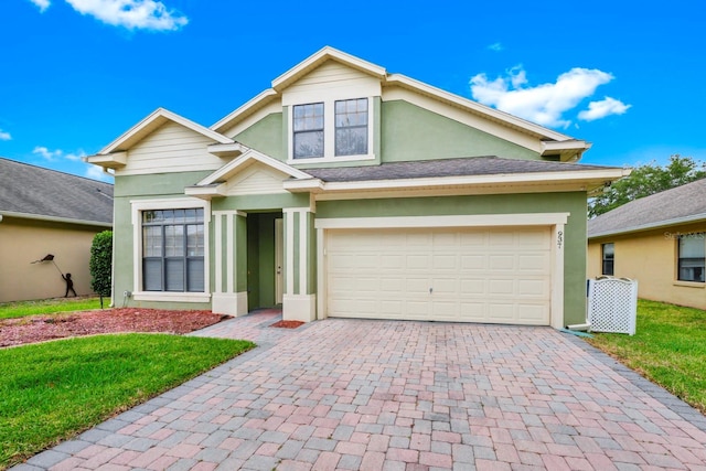 view of front of home with a garage and a front yard