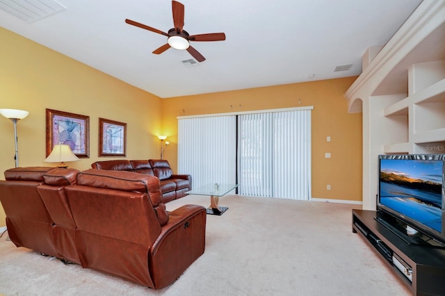 living room with ceiling fan and carpet flooring