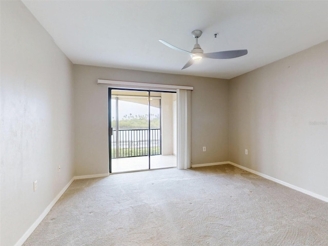 carpeted spare room with ceiling fan