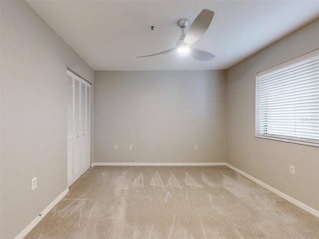 unfurnished room with light carpet and ceiling fan