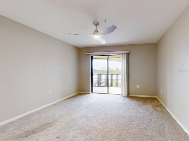 spare room with ceiling fan and light carpet