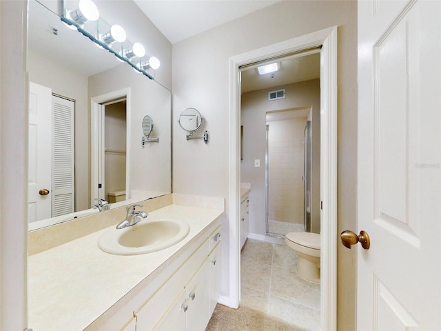 bathroom with vanity, toilet, and an enclosed shower