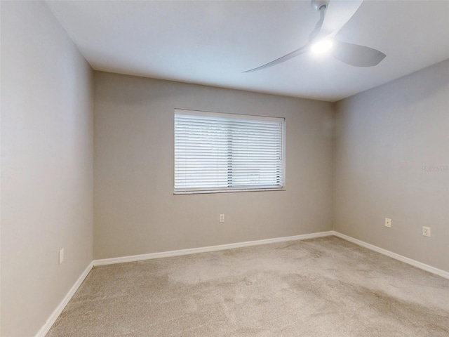 empty room with ceiling fan and light colored carpet