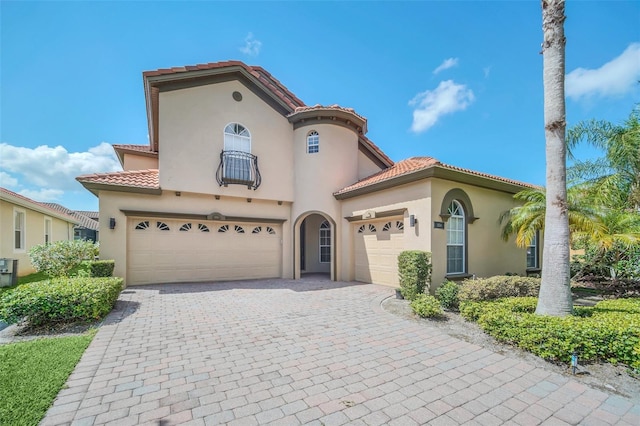 mediterranean / spanish-style house with a garage