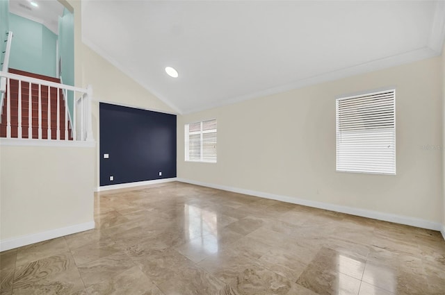 tiled empty room featuring ornamental molding and high vaulted ceiling