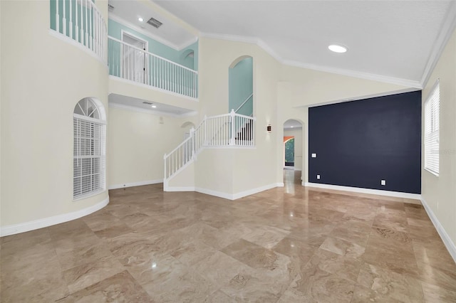 unfurnished living room featuring a high ceiling, crown molding, and tile floors