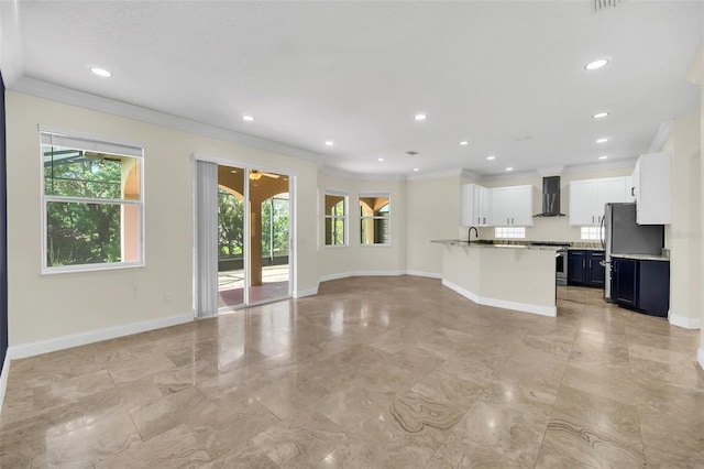 unfurnished living room featuring sink, light tile floors, and ornamental molding