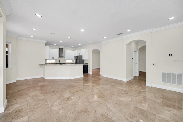 unfurnished living room featuring crown molding and light tile floors