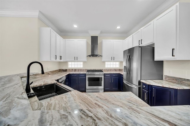 kitchen featuring wall chimney exhaust hood, stainless steel appliances, blue cabinets, and sink