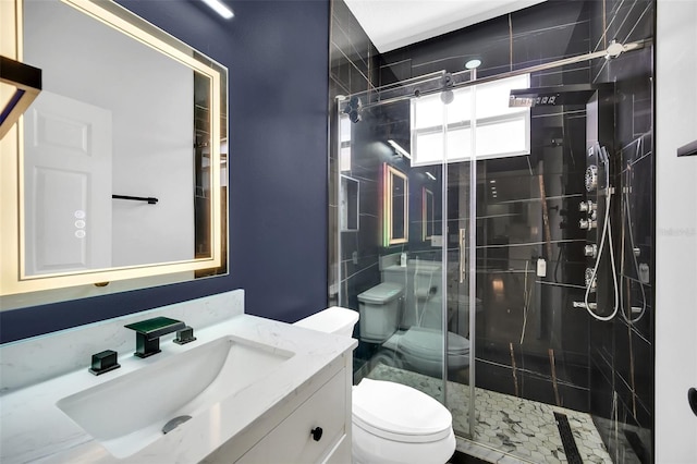 bathroom with an enclosed shower, vanity, and toilet