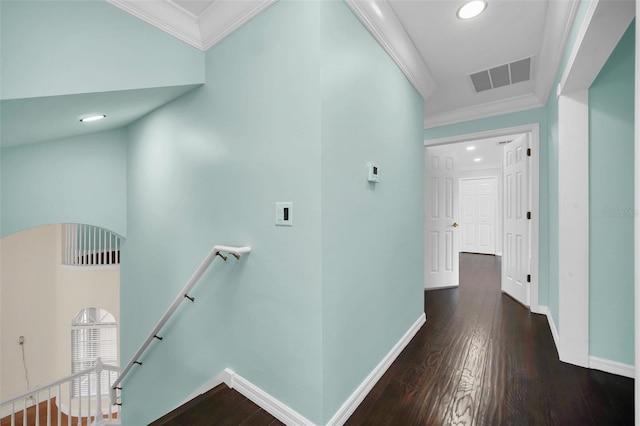 corridor featuring ornamental molding, dark hardwood / wood-style flooring, and a towering ceiling