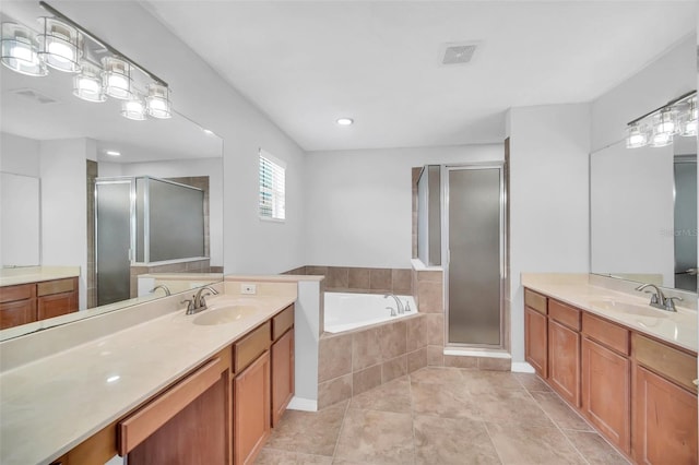 bathroom with independent shower and bath, vanity, and tile floors