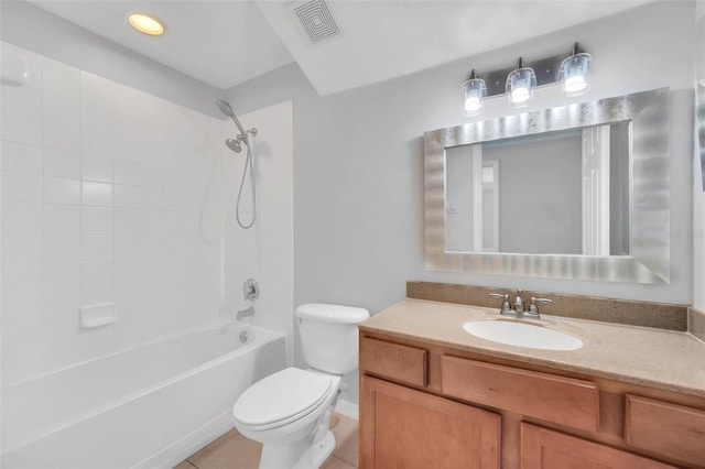 full bathroom with tile flooring, tiled shower / bath, toilet, and vanity with extensive cabinet space