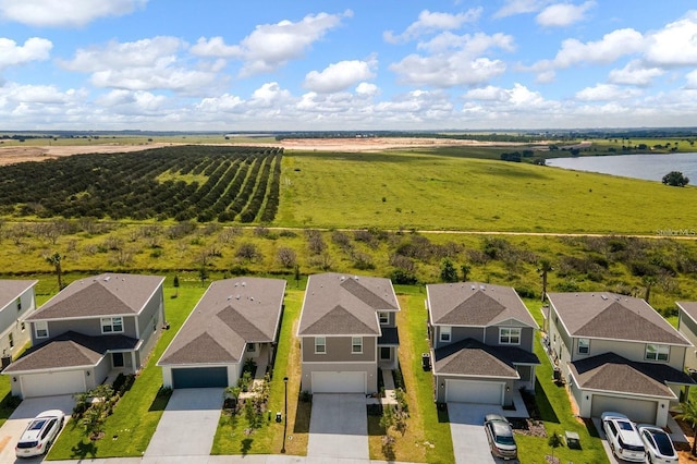 drone / aerial view with a water view and a rural view