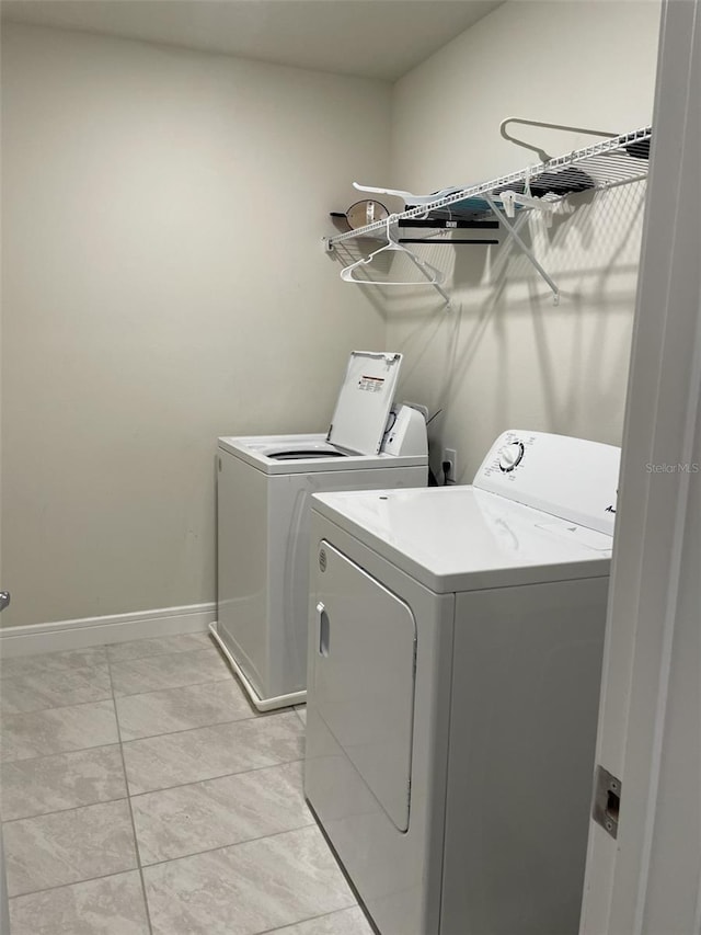 laundry area with light tile patterned flooring and independent washer and dryer