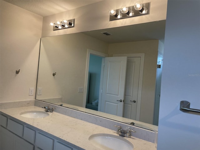 bathroom with vanity and a textured ceiling