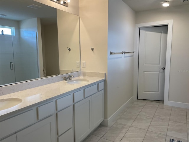 bathroom featuring an enclosed shower, vanity, and tile patterned flooring