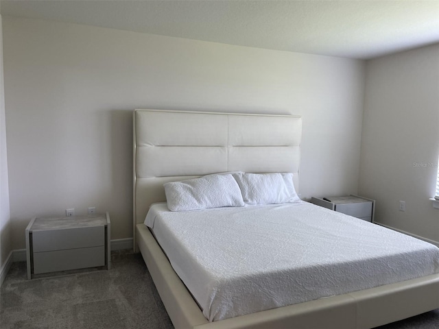 bedroom with dark colored carpet