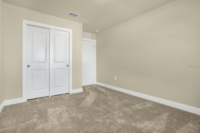 unfurnished bedroom with carpet and a closet