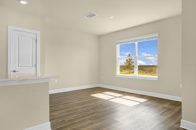 unfurnished room featuring dark hardwood / wood-style floors