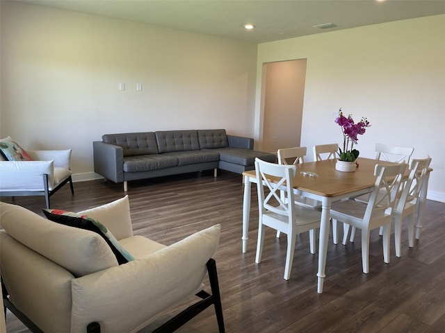 dining space with dark hardwood / wood-style flooring