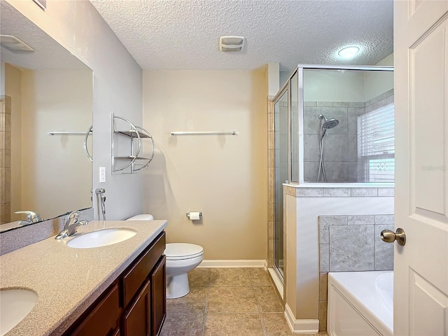 full bathroom featuring vanity, toilet, a textured ceiling, and independent shower and bath