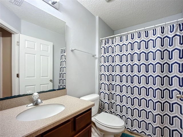 bathroom featuring a shower with curtain, vanity, a textured ceiling, and toilet