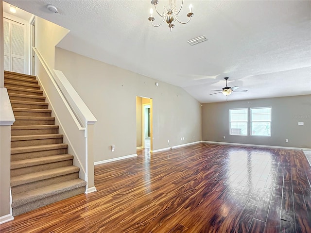 unfurnished living room with ceiling fan with notable chandelier, wood-type flooring, a textured ceiling, and vaulted ceiling