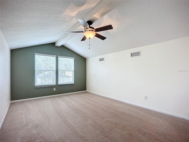 carpeted spare room with a textured ceiling, vaulted ceiling with beams, and ceiling fan