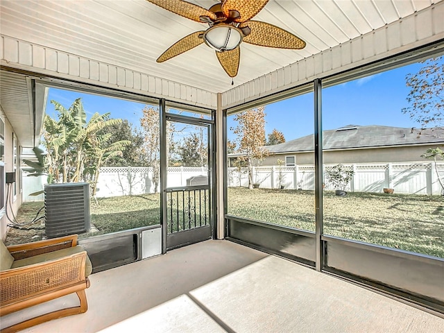 sunroom with ceiling fan and wooden ceiling