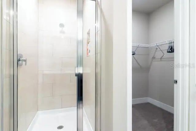 bathroom featuring a shower with door