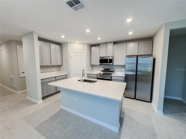 kitchen with gray cabinets, sink, and stainless steel appliances