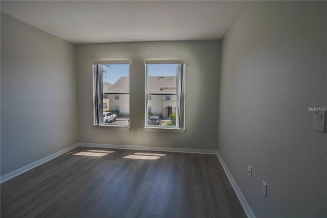 unfurnished room featuring dark wood-type flooring