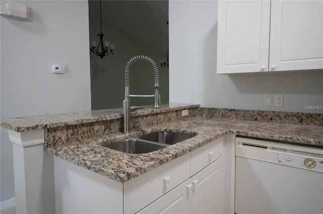 kitchen featuring dishwasher, white cabinetry, sink, and light stone counters