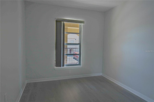 spare room featuring wood-type flooring