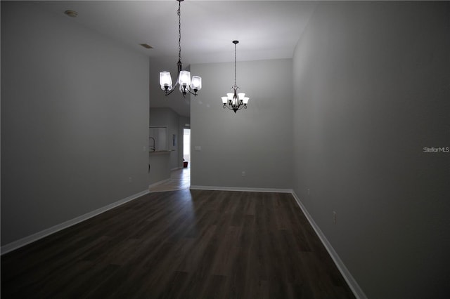 unfurnished room with hardwood / wood-style floors and an inviting chandelier