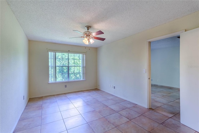 tiled empty room featuring a textured ceiling and ceiling fan