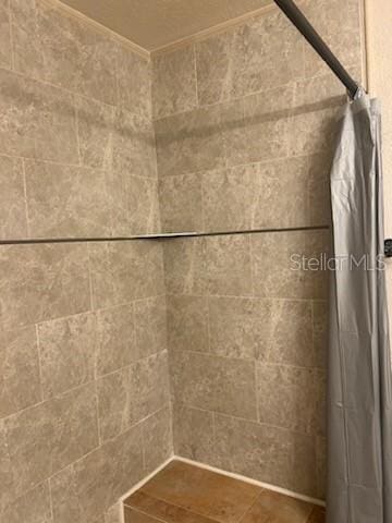 interior details featuring a shower with curtain