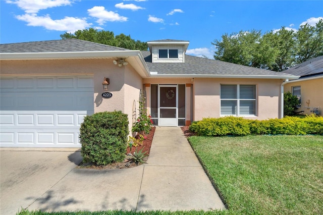 view of front of home featuring a front yard and a garage