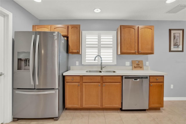 kitchen featuring sink, appliances with stainless steel finishes, and light tile flooring