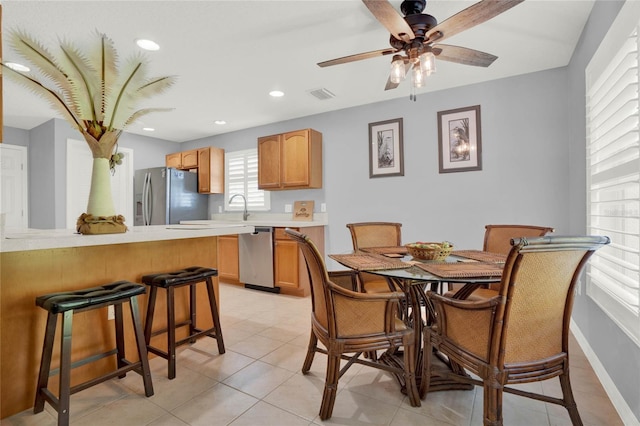 dining area featuring ceiling fan and light tile floors