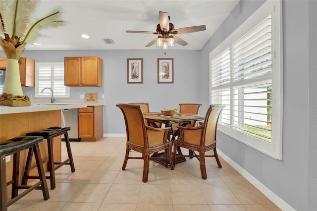 dining space featuring ceiling fan and light tile floors