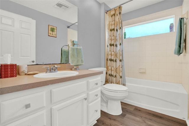 full bathroom featuring hardwood / wood-style flooring, toilet, vanity, and shower / tub combo with curtain