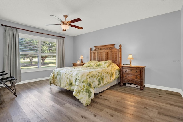 bedroom with ceiling fan and hardwood / wood-style flooring