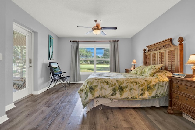 bedroom featuring wood-type flooring, ceiling fan, and access to outside